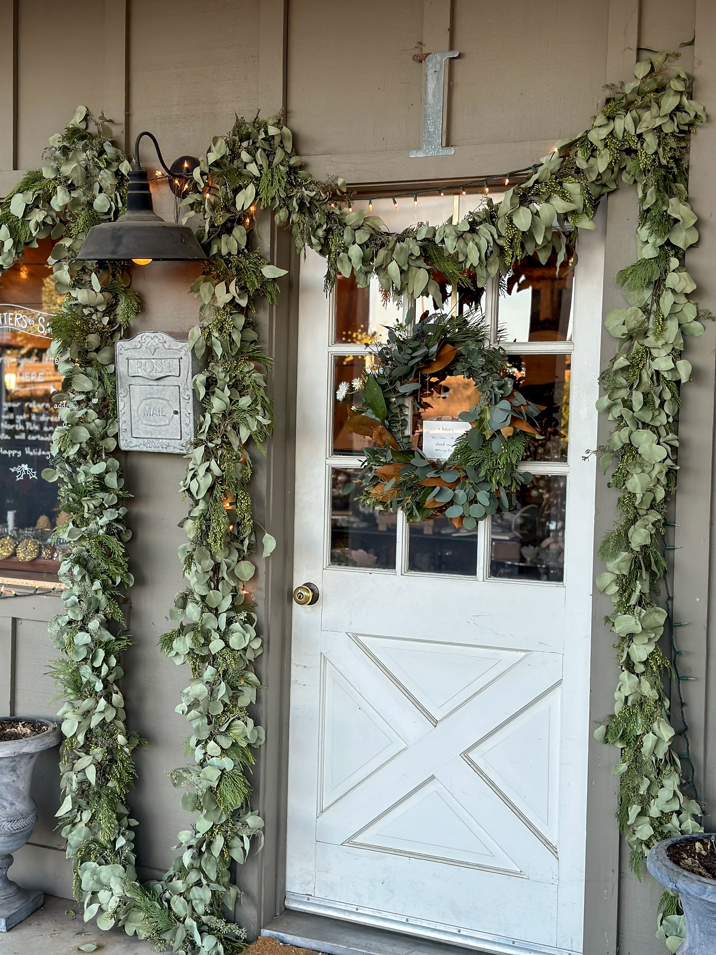 Christmas greenery and wreath framing a front doorway in Des Moines Iowa